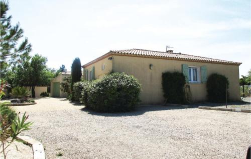 a house with a gravel driveway in front of it at Amazing Home In Cruzy in Cruzy
