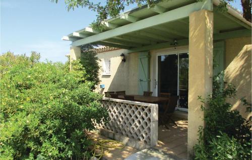 a porch of a house with a wooden table at Amazing Home In Cruzy in Cruzy