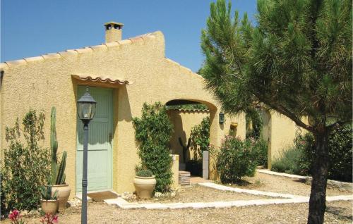 a house with a green door and a tree at Amazing Home In Cruzy in Cruzy
