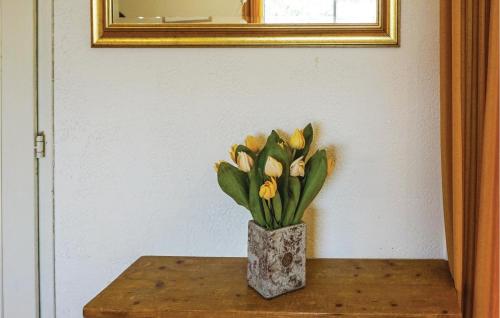 a vase of yellow flowers sitting on a table at Amazing Home In Cruzy in Cruzy