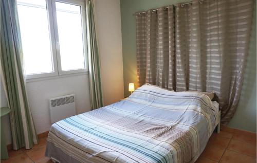 a bed in a bedroom with two windows at Amazing Home In Cruzy in Cruzy
