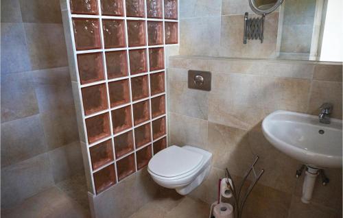 a bathroom with a toilet and a sink at Amazing Home In Cruzy in Cruzy