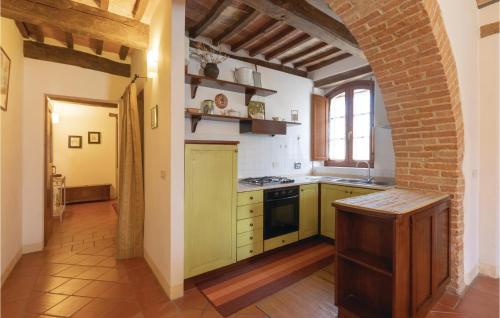 a kitchen with yellow appliances and a brick wall at La Spizzica 1 in Baccano