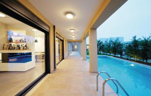 a swimming pool in the middle of a building at Awesome Home In Rethymno Crete in Sfakaki