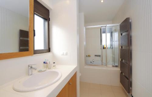 a white bathroom with a sink and a mirror at Awesome Home In Rethymno Crete in Sfakaki