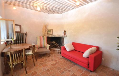 a living room with a red couch and a table at 1 Bedroom Beautiful Home In Saignon in Saignon