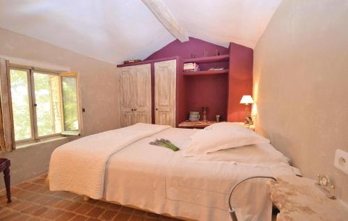 セーニョンにあるNice Home In Saignon With 1 Bedrooms And Wifiの紫の壁のベッドルーム1室(大型ベッド1台付)