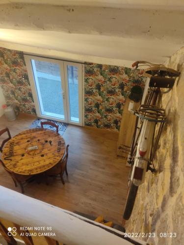 un vélo suspendu sur un mur à côté d'une table dans l'établissement Petite maison de caractère 4 ou personnes, à La Turballe