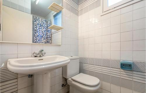 a white bathroom with a sink and a toilet at 6 Bedroom Gorgeous Home In Matadepera in Matadepera