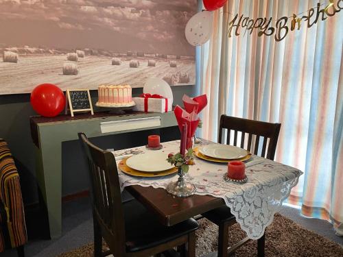 a dining room table with a cake on it at Marion Lodge in Johannesburg