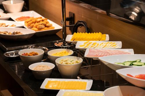 a buffet line with many different types of food at hotel H2 TRIP&BUSINESS NAGASAKI in Nagasaki