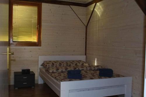 a bedroom with a bed in a wooden wall at Flora&Fauna in Bihać