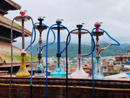 a group of colorful lamps sitting on a ledge at Hotel Empire & Rooftop Restaurant in Bhaktapur