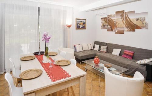 a living room with a table and a couch at Nice Home In Salazac With Jacuzzi in Salazac