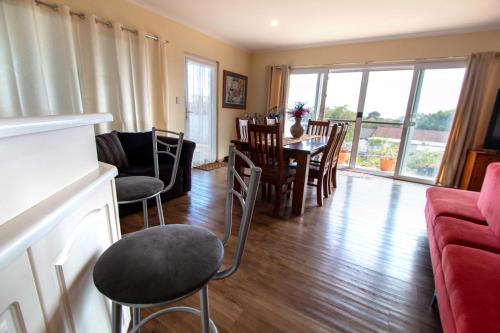 a living room with a dining room table and chairs at TryOver in Meningie