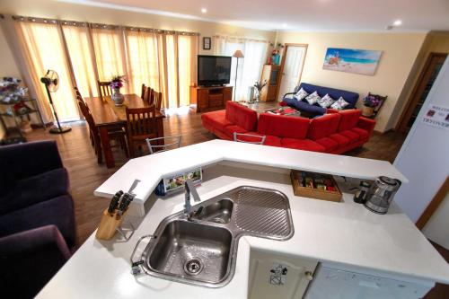 a kitchen and living room with a sink and a couch at TryOver in Meningie