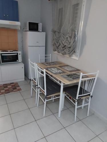 a kitchen with a table and chairs and a stove at The Best Choice in Preveza