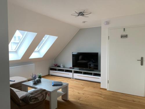 a living room with a couch and a tv at Ferienwohnung Alois in Ueckermünde