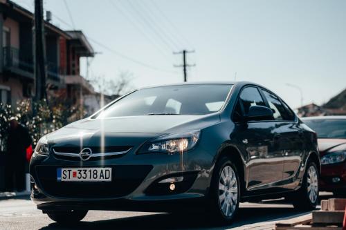 a black car is driving down a street at Urbanista Hotel & Bar in Štip