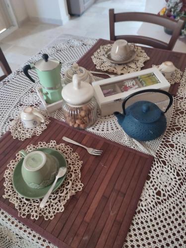 a wooden table topped with plates and dishes on a table at Casedda Ostunese in Ostuni