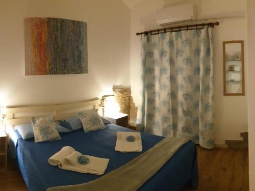 Ένα ή περισσότερα κρεβάτια σε δωμάτιο στο B&B Cala Luna