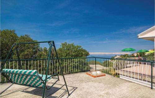 a swing on the balcony of a house at Holiday Home Baric Draga Ii in Barić Draga