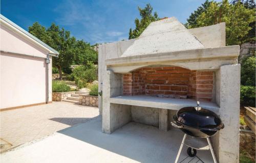 a bbq grill in front of a brick oven at Holiday Home Baric Draga Ii in Barić Draga