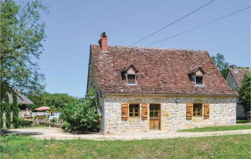 an old stone house with a red roof at Cozy Home In Padiracbascoul With Wifi in Padirac