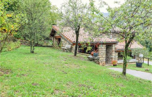 a house with a grass yard in front of it at 1 Bedroom Gorgeous Home In Thueyts in Thueyts