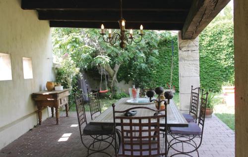 a patio with a table and chairs on a patio at 2 Bedroom Beautiful Home In Bellegarde in Bellegarde