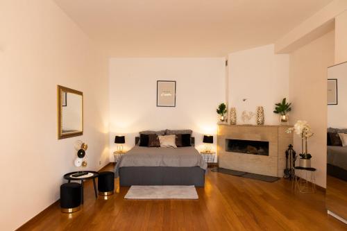 a bedroom with a bed and a fireplace at ClickTheFlat Legionowo Apart Rooms in Legionowo