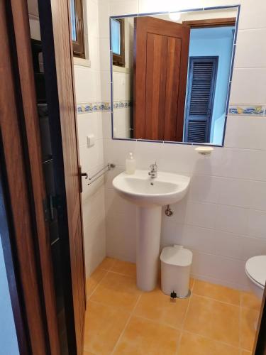 a bathroom with a sink and a mirror at Villa 88 in Almancil