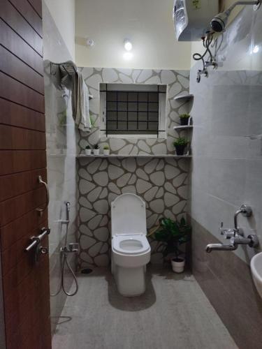 a bathroom with a toilet and a sink at 2390 Home Tales by Tipiverse, HSR Layout in Bengaluru