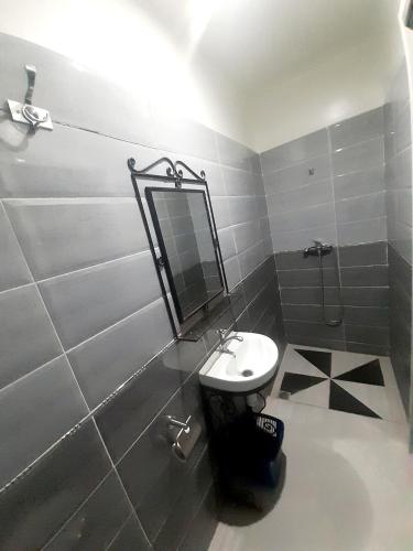 a bathroom with a sink and a shower and a mirror at Hotel salem leksor in Marrakech