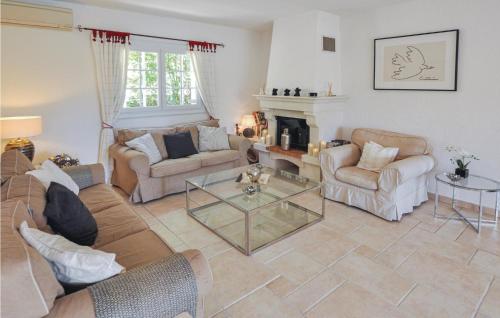 a living room with a couch and chairs and a fireplace at 4 Bedroom Cozy Home In Montauroux in Montauroux