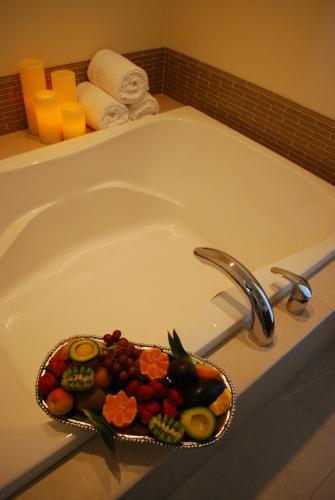 a tray of fruit sitting in a bath tub at Bella Capri Inn and Suites in Camarillo