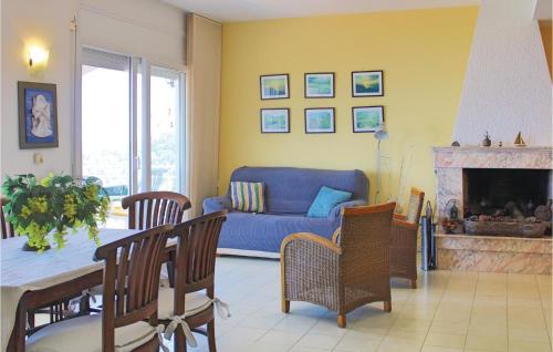 a living room with a blue couch and a table at Nice Home In Blanes With Wifi in Blanes