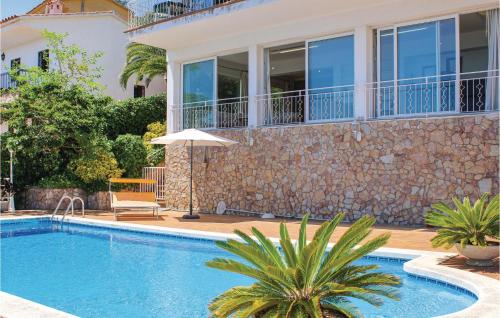 a villa with a swimming pool and a house at Nice Home In Blanes With Wifi in Blanes