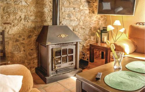 a living room with a wood stove in it at Awesome Home In Villanueva Del Duque in Villanueva del Duque