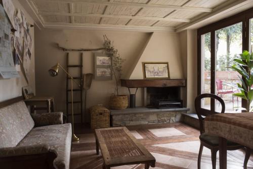 a living room with a couch and a fireplace at La Bugia del Sensale in San Donato in Poggio