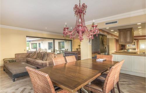 a dining room with a table and a chandelier at Amazing Home In Cabrils With Wifi in Cabrils