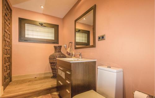 a bathroom with a sink and a mirror and a vase at Amazing Home In Cabrils With Wifi in Cabrils