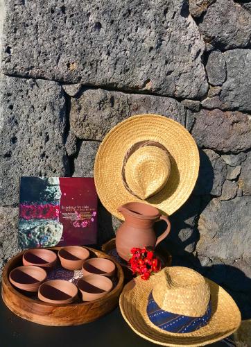 a basket with a hat and some brown cupcakes at Adega da Prainha in Prainha de Baixo
