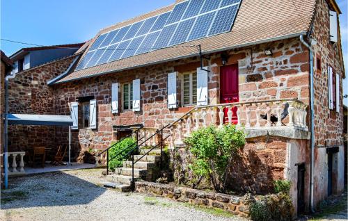 a brick house with solar panels on the roof at Gorgeous Home In Badefols D'ans in Teillots