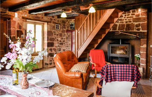 a living room with a couch and chairs and a staircase at Gorgeous Home In Badefols D'ans in Teillots