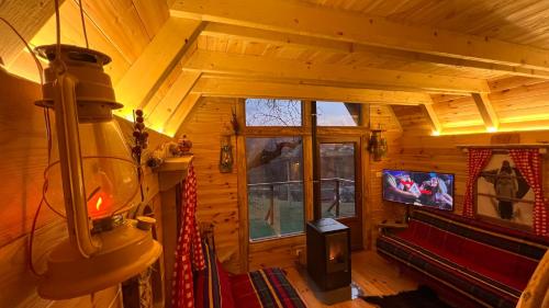 a living room with a large window in a cabin at Tara Place - Camp Rabrenovic in Mojkovac