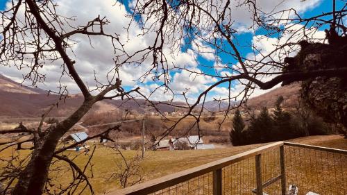 a view of a valley with a fence and mountains at Tara Place - Camp Rabrenovic in Mojkovac