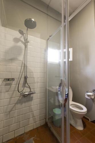 a bathroom with a shower and a toilet at The Grand Meshmosh Hotel in Beirut