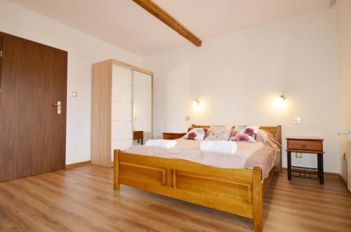 a bedroom with a large bed and a wooden floor at Dwór Roh in Wetlina