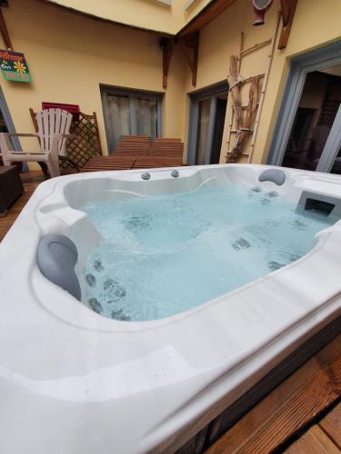 a jacuzzi tub sitting on a deck with at Le Patio de Luchon in Luchon